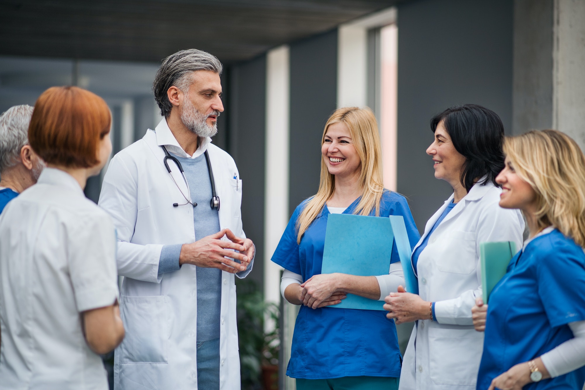Group of doctors standing in hospital on medical conference.