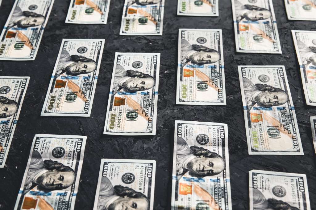 One hundred dollar bills are creatively laid out. Business concept, development perspective