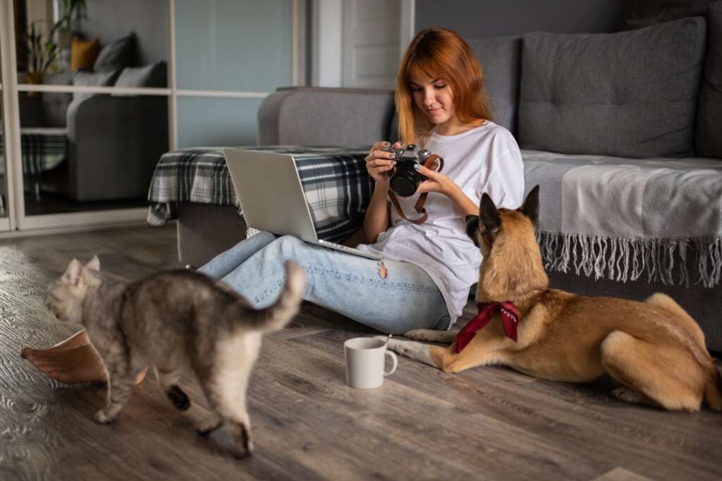Photographer looking through photos near pets